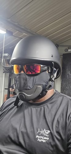 Reviewer wearing the flat black Switchback Reversible Helmet in the backwards OG style inside a garage.