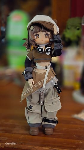 Reviewer's Electronic Pet Game BJD figure in a stylish brown and beige outfit, standing on a wooden surface.
