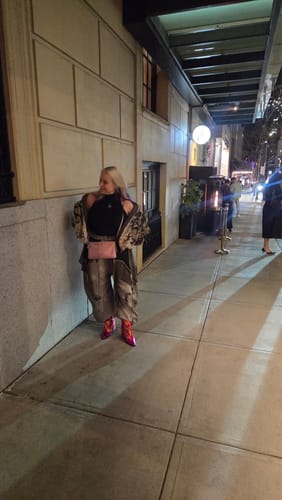 Reviewer wearing the Personsoul Snake Print Faux Fur Jacket open over their shoulders for an oversized look at night.