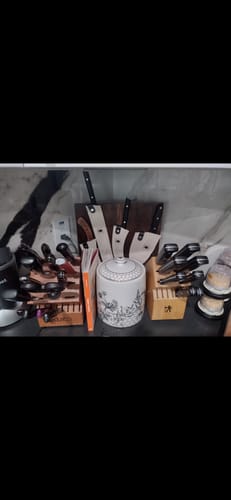 Customer's mystery knife set displayed on a kitchen counter among other cutlery blocks.