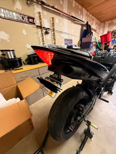 Reviewer's black Yamaha R1 on a stand, showing the clean installation of the tail tidy under the seat.