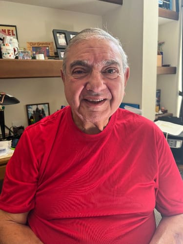 A smiling reviewer in a red shirt, providing a positive review for the compression socks.