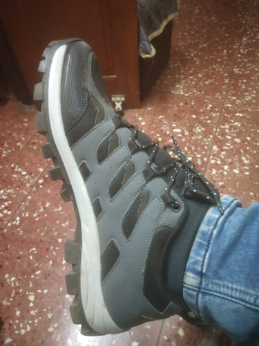 Customer wearing a grey and black Bacca Bucci EverTrek hiking boot with a rugged sole.