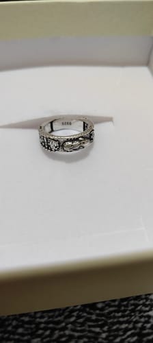 Reviewer's detailed silver PiXiu ring shown from the side in its white presentation box.