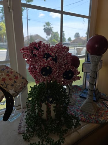 Customer's Americana Fabric Sunflowers arranged in a patriotic display on a windowsill with other decorations.