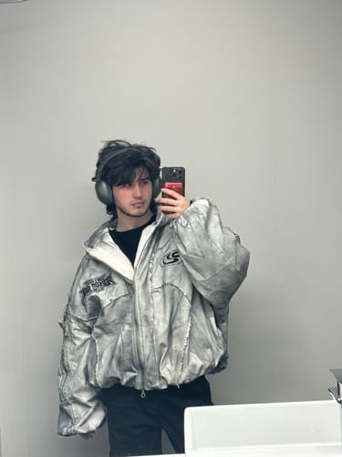 Reviewer taking a mirror selfie wearing the baggy Personsoul Hand Brushed Dirty Cotton Jacket.