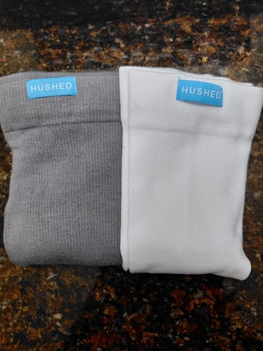 Customer's grey and white Performance Eucalyptus Compression Socks folded on a countertop.