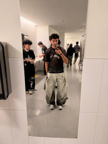 Reviewer showing the fit of the baggy Personsoul Denim Jeans in a full-length mirror selfie.