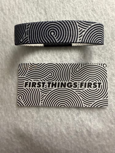 Customer's First Things First Bracelet and its matching card, both showing a black-and-white circular line pattern.