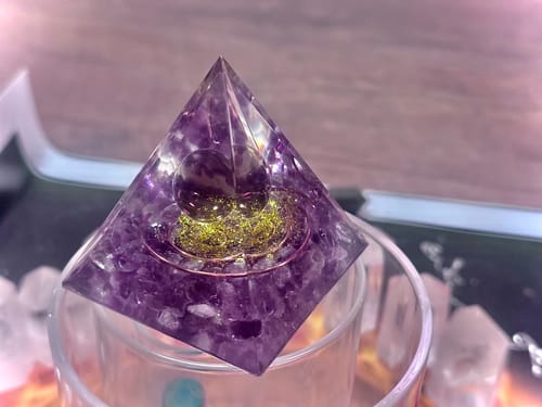 Reviewer's Smoky Quartz Amethyst Obsidian Pyramid showing its purple crystals, inner sphere, and gold details.