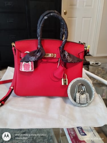 Customer's red LALUVA Warkin Bag shown on a table with a decorative scarf wrapped around the handle.
