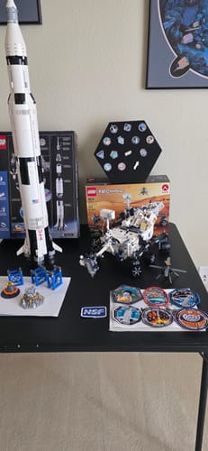 Customer's Starship Flight Pin Collection on its black display mount, shown on a table with other space-themed items.