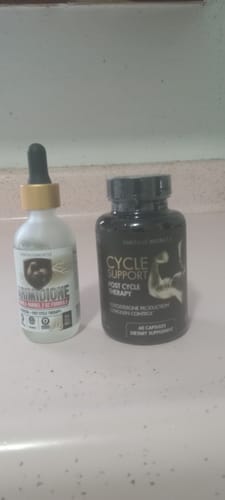 Customer's black bottle of Cycle-Support on a counter next to another supplement bottle.