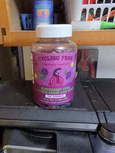 Reviewer's jar of Blackberry Yuzu Live Resin Gummies sitting on a shelf in a cabinet.