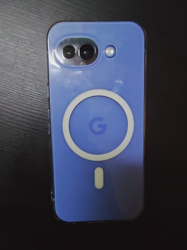 Reviewer's blue Google Pixel phone shown inside the clear Anti Yellow Magsafe Case, lying on a dark surface.