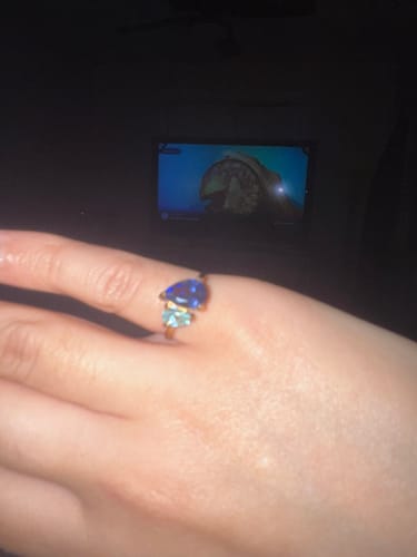 Close-up of a customer's Leesha Birthstone Ring, showing its large dark blue and smaller light blue stones.