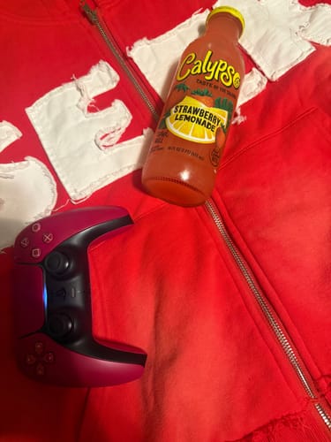 Customer's red SEEK ZIPUP hoodie laid out, showing the white distressed lettering on the chest.