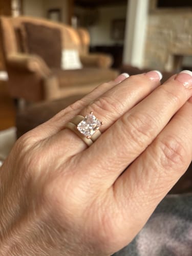 Close-up of a customer's hand wearing the Emerald Cut CZ Silicone Ring Set, showing the large stone and wide band.