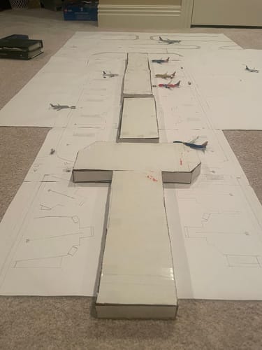 Customer's Gemini Southwest 737-800 model on a handmade airport layout with other detailed model airplanes on a floor.
