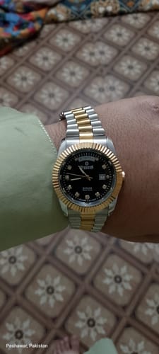 Customer showing their Sveston Royale watch with a two-tone band and a black dial.