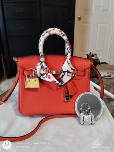 Reviewer's orange LALUVA Warkin Bag with a decorative scarf wrapped around the top handle, shown indoors.