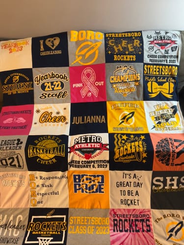 Customer's large T-Shirt Quilt created from their daughter's various colorful cheerleading and school 'Rockets' t-shirts.