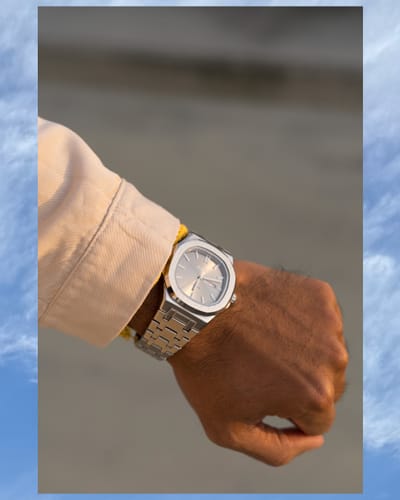 Reviewer's wrist wearing the elegant Lucky Fours® Brone watch with its champagne-toned dial.