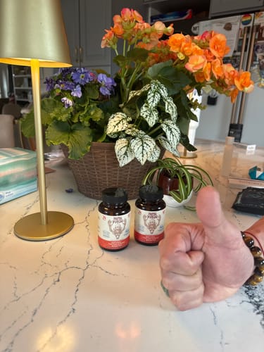 Reviewer gives a thumbs-up next to two bottles of Primal Reindeer Testosterone Support on a kitchen counter.