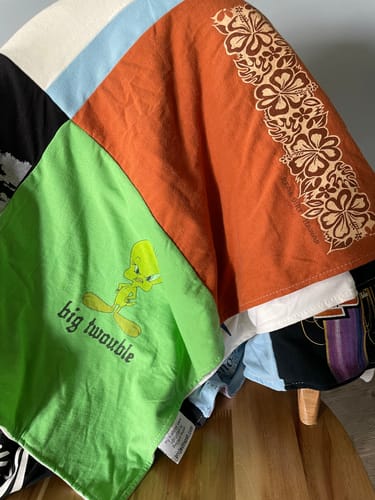 Close-up of a customer's colorful Double Sided T-Shirt Quilt, showing patches from different shirts.