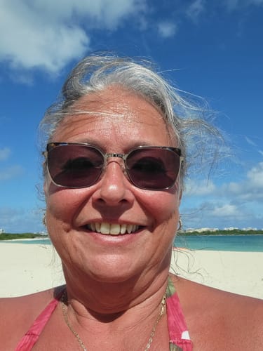 Reviewer showing their gray hair at the beach before using the organic rosemary shampoo.