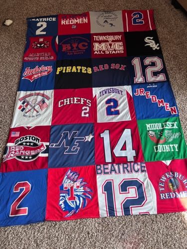 Customer's large Project Repat T-Shirt Quilt made from a colorful collection of sports jerseys and t-shirts.