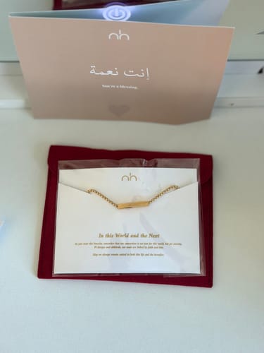 Customer's 'In This World and the Next Bracelet' shown in its gift packaging with a red pouch and accompanying message cards.