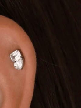 Close-up of a reviewer wearing the sparkly Toi et Moi flatback Silver earring on their ear cartilage.