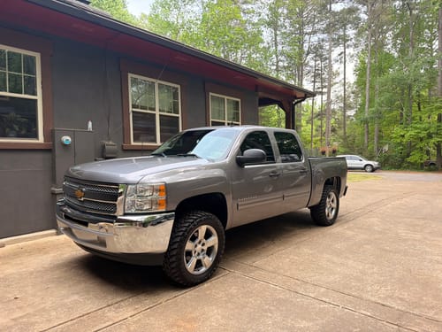 Customer's gray Silverado 1500 with a taller stance after installing the 3-inch lift kit.
