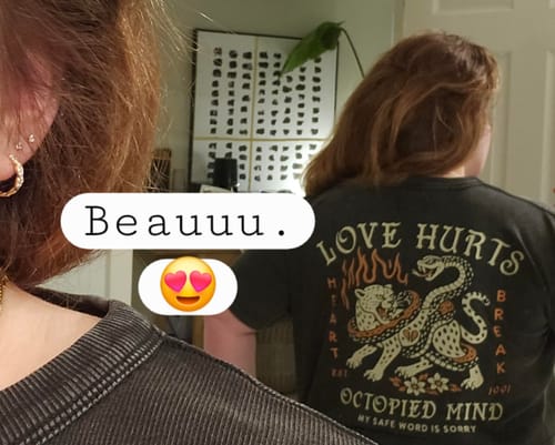 Reviewer from behind wearing the Love Hurts T-Shirt, showing the detailed back graphic of a leopard and snake.