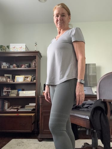 Customer standing in a room wearing grey, textured 3D Anti-Cellulite Leggings to show the fit.