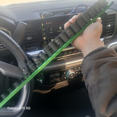 Customer holding the Stubby Impact Socket Set on a green magnetic rail inside a vehicle.