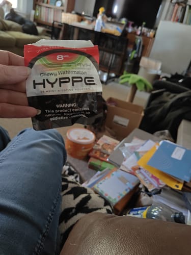 Customer holding a package of HYPPE Chewy Watermelon Moist Nicotine Pouches.
