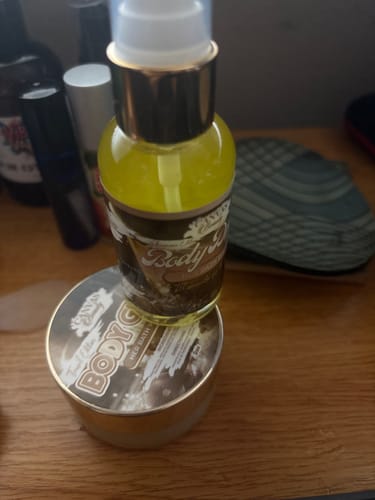 Customer's HER BATH WATER discovery set, showing the pump bottle and jar on a wooden surface.