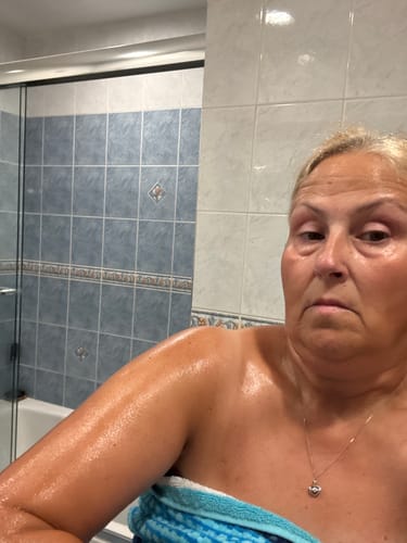 Customer shows off their glowing and moisturized tanned skin after using the Seaside Body Balm.