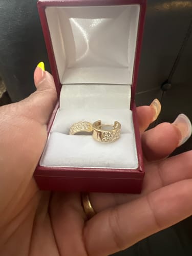 Customer holding the 14k Small Round Hoop CZ Earrings inside a red jewelry box.