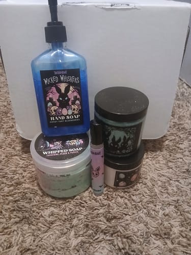 Customer showing the items received in their Monthly Subscription Box, including soap and perfume.
