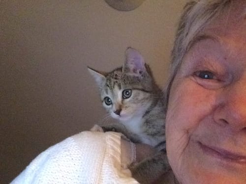 A happy customer pictured in their review of the ClarityMax wireless hearing aid.