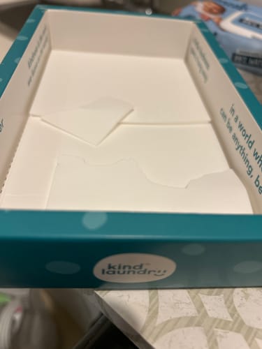 Customer's open teal box of Laundry Detergent Sheets with a few white sheets left inside.