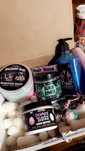 Customer's unboxed Monthly Subscription Box showing themed body butter, scrub, and soap.
