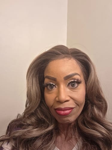 Customer's close-up showing the hairline of the long, wavy Outre Elara wig.