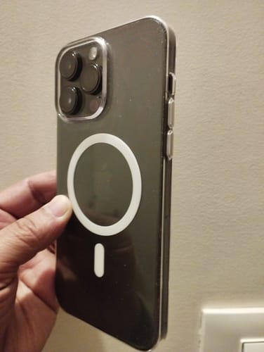 Customer holding an iPhone 14 Pro Max in the clear Magsafe case, showing the protective back and side buttons.