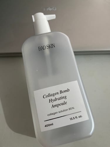 Customer's Bad Skin Collagen Bomb Hydrating Ampoule in a large, frosted pump bottle.