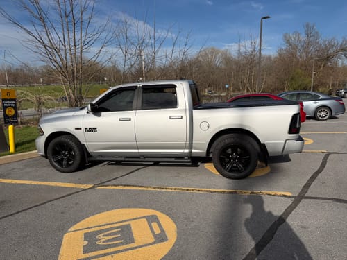 Customer's clean, dry silver Ram truck in a parking lot, showing the results of the drying towel.