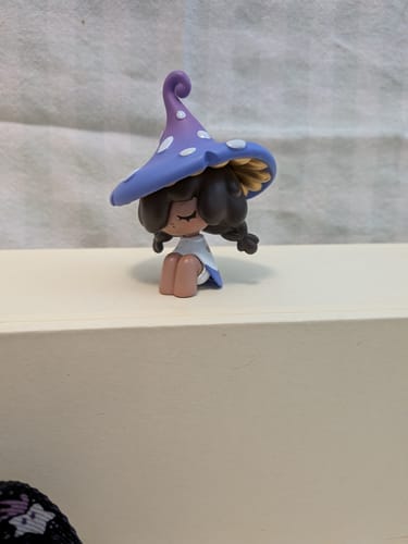 Customer's Moogutong Little Mushroom Girl figurine with a purple polka-dot hat, sitting on a white shelf.